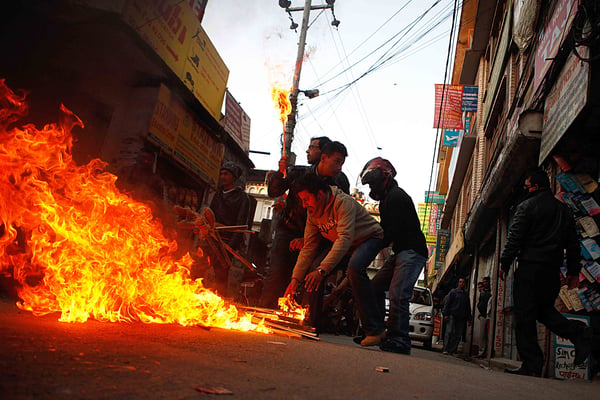 WE DIDN'T START THE FIRE: Students of Nepal Student Union (NSU) light their torches in preparation for a protest rally against PM Baburam Bhattarai at Bagbajar on Sunday.