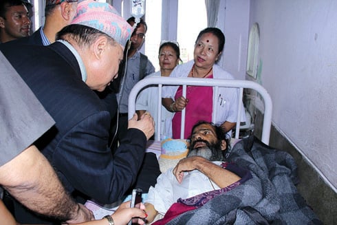 GOING STRONG: Health Minister Bidhyadhar Mallik meets Nanda Prasad Adhikari at Bir Hospital on Tuesday. The Adhikari couple have been on a hunger strike to demand justice for their son Krishna, who was killed by the Maoists during the war.