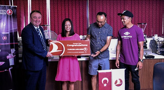 Turkish Airlines Country Manager Abdullah Tuncer (far left) and Anand Gurung and Gagan Pradhan of Himalayan Java present the winner of their joint campaign "Together for Better" with the grand prize on Friday in Thamel, Kathmandu.