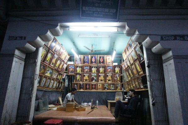 A shopkeeper working on photo frames in a shop in Phuntsoling, Bhutan on Monday. The shop exclusively only frames photos of the King and Queen of Bhutan and Lord Buddha.