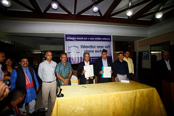 Rabindra Mishra of the Sajha Party and Ujjwal Thapa of Bibeksheel Nepali after the unification of their parties in Kathmandu on Wednesday. The name of the new party will be Bibeksheel Sajha Party. - Bikram Rai