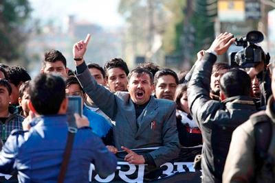 NO MORE: A man protests against PM Baburam Bhattarai demanding to punish murders of journalist Dekendra Thapa at Exhibition Road on Tuesday.