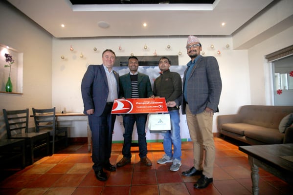 General Manager of Turkish Airlines Abdullah Tuncer Kececi and Abhishek Bikram Shah, General Manager of Chandragiri Hills present the prizes to the winners of 'Ride to fly' campaign on Thursday.