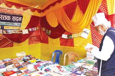 BOOK WORM: An elderly man looks over books at the Art and Literary Festival 2069 in Kakarvitta organised by Readers Jhapa.