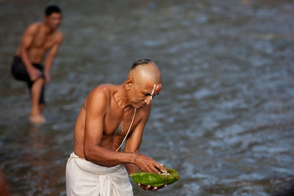 A devotee performs rituals on the occasion of Kuse Aunsi or Father's Day at the Bagmati River in Gokarna Temple on Sunday. People all over the country, whose fathers have passed away, come to the temple for worship and to present offerings.