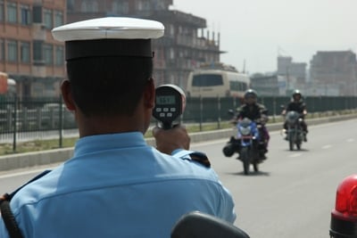 NEED FOR SPEED: A traffic police near Sallaghari, Bhaktapur uses a radar gun to measure the speed of vehicles on Monday.