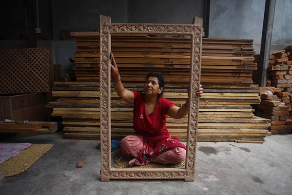 Motimaya Shakya, 50 polishes a wooden frame at Patan Industrial Area on Friday.