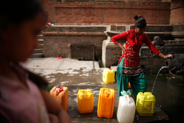 17-year-old Meena Tamang fetches water from Manga Hiti, Patan on Monday. The monsoon has revived many of the dry waterspouts in the Valley.