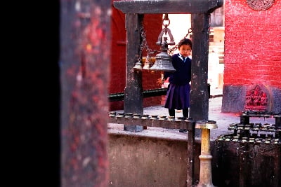 RINGTONES: A young girl rings a bell at the Banglamukhi Temple in Patan on Sunday.