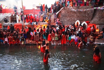 COLD BATH, WARM HEART: Women take a dip in the Salinadi River after praying for the good health and prosperity of their families on the first day of Swasthani festival at Sankhu on Sunday.