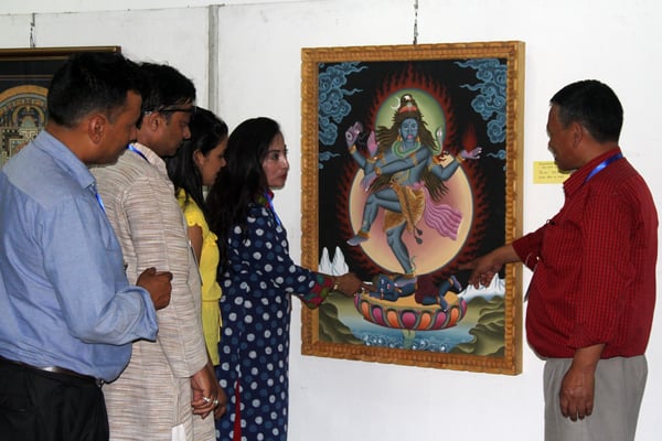 Artist Ram Lama showcasing his artwork to visitors at the Nepal Fine Arts Academy at Naxal on Monday.