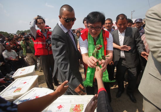 Hollywood actor Jackie Chan receives a rose from an earthquake survivor in Jawalakhel on Tuesday.