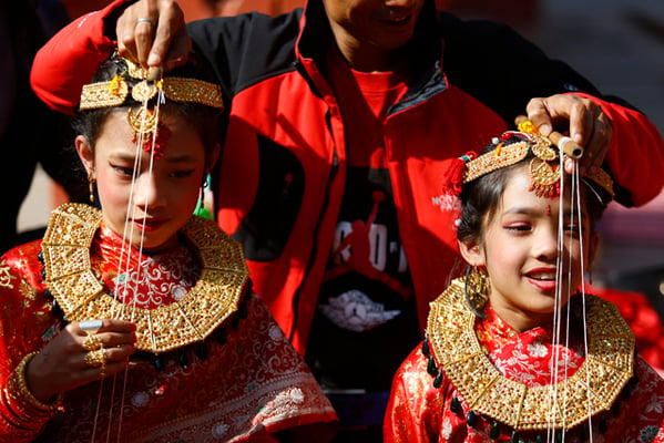 Girls from Newar community participate in Ihi also known as Bel Bibaha in Banglamukhi on Wednesday.