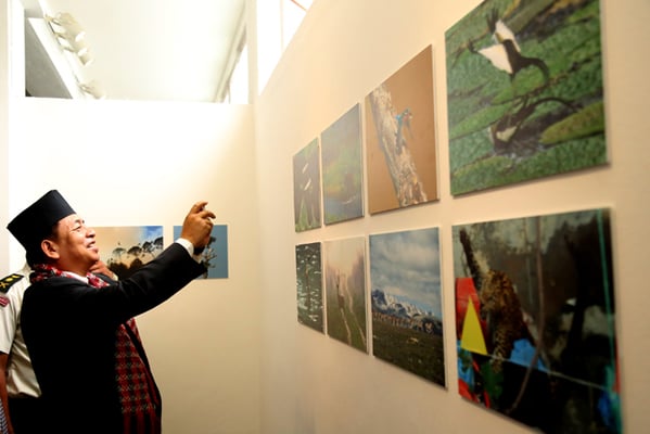 Deputy President Nanda Kishor Pun takes a picture during a photo exhibition organised by the Photojournalist Club at Nepal Art Council, Babarmahal on Monday.