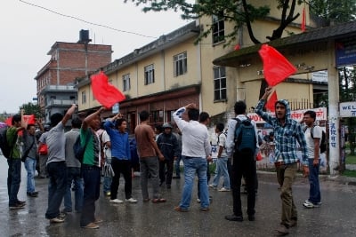 WAVING FLAGS: Students protest against Tribhuvan University administration for their decision to postpone elections in Patan on Thursday.