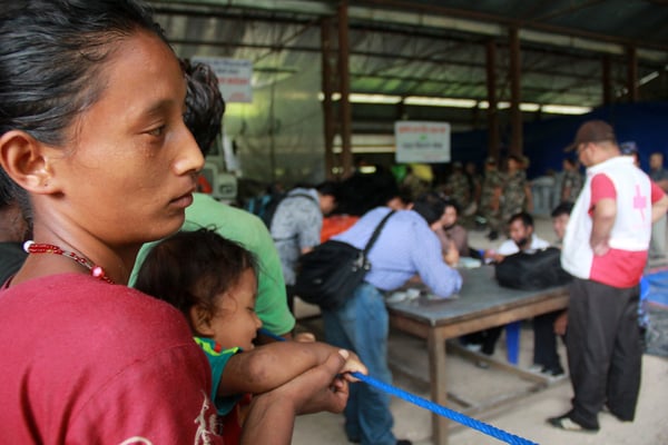 Chameli (left), a Bhote Koshi landslide victim, waiting to receive aid money from officials on Friday.