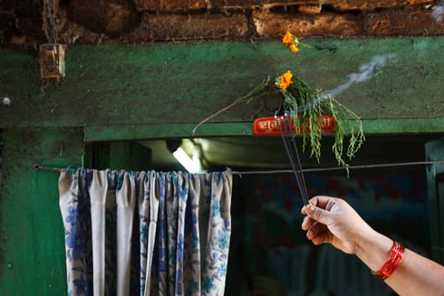 AUSPICIOUS START: A tea shop owner in Basantapur lights incense sticks before starting the day on Wednesday morning.