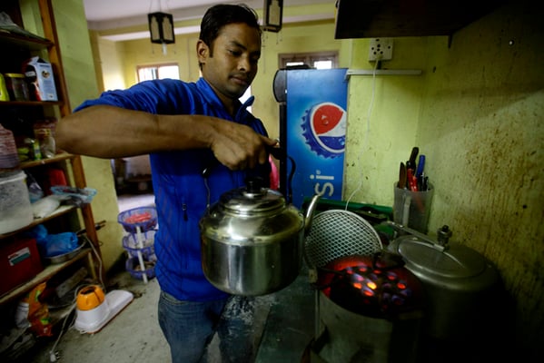A cook in a restaurant uses briquette in Kathmandu as fuel shortage worsens due to an unofficial trade embargo by India.