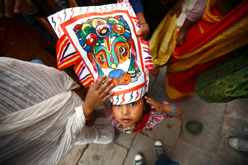 LIFE AFTER DEATH: A girl participates in the Gai Jatra festival at Basantapur on Thursday. On this day, people dress up as cows and ascetics to commemorate family members who have died in the past year.