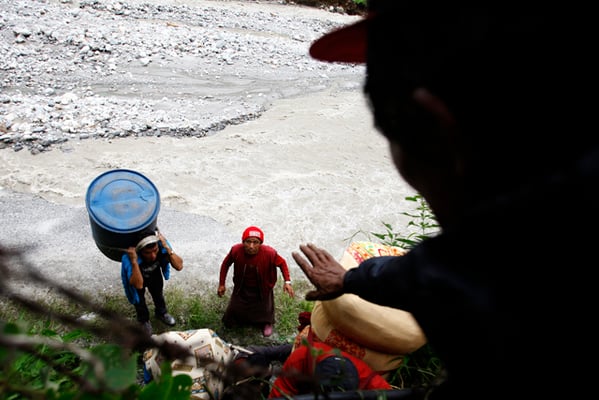 Residents of Tatopani move to a safer location after being displaced by the flash flood in Bhotekosi on Saturday. The flash flood has added to the woes of the earthquake victims.