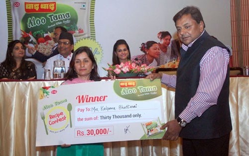Kalpana Bhattarai, the winner of the new 'Aaloo Tama' flavoured brand Wai Wai cooking contest, receives the prize at an event in Kathmandu on Monday.