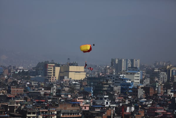 A Nepal Army paratrooper prepares to land in Khula Manch, Kathmandu after jumping off a military helicopter on Nepal Army Day on Friday.