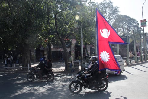 BANDA NO MORE: A man rides with the flag of Nepal to protest the 10 day strike imposed by the CPN-M.