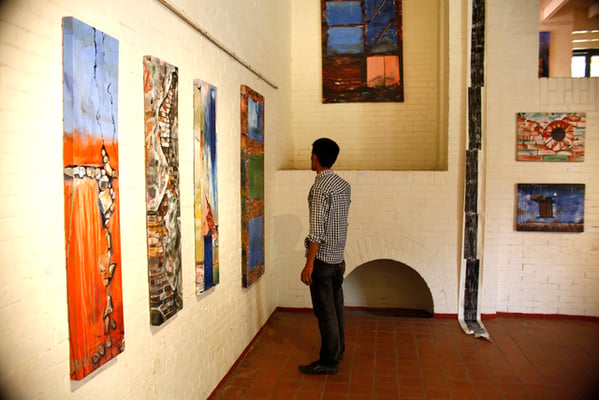 A man browses through paintings of artist Bishal Manandhar at his solo exhibition titled 'Emotional Walls' in The Taragaon Museum, Hyatt Regency Kathmandu on Sunday.