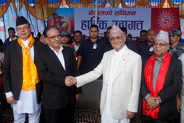 UCPN(M) Chairman Pushpa Kamal Dahal and UML Chairman KP Sharma Oli shake hands during the tea party organised by CPN-UML to celebrate the announcement of the constitution at the Dasarath Stadium on Tuesday.