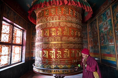 A Tibetan Buddhist nun turns a prayer wheel at Boudha on the first day of Gyalpo Losar on Thursday.