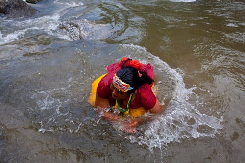 A Hindu devotee takes a dip in the Bagmati river at Sundarijal on the first Monday of the Nepali month Shrawan.