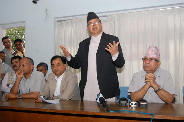 UML Chairman Jhal Nath Khanal talk during their second-last press meet ahead of the party's national convention in Balkhu on Monday.