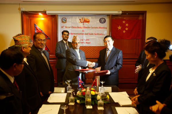 Deputy Director General of Nepal's Department of Customs Damodar Regmi and his Chinese counterpart from Lhasa Long Chengwei sign a deal in Kathmandu on Thursday to improve trade links between the two countries.