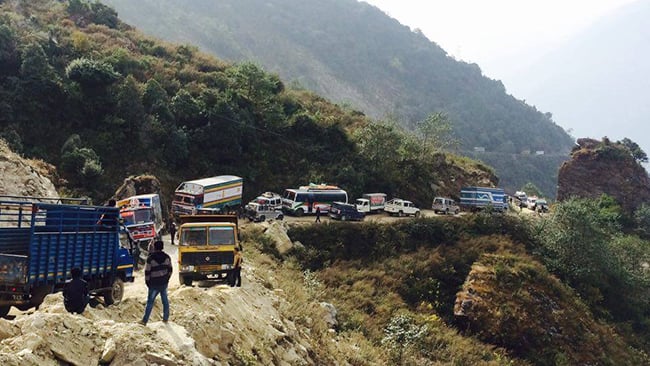 Vehicles navigate along the precarious road on the way to Rasuwagadhi near the Nepal-China border on Wednesday.