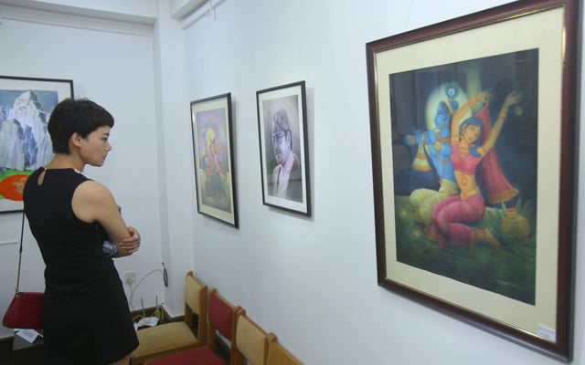 A visitor looks at a collection of paintings in Music Art Gallery, Jhamsikhel on Saturday.