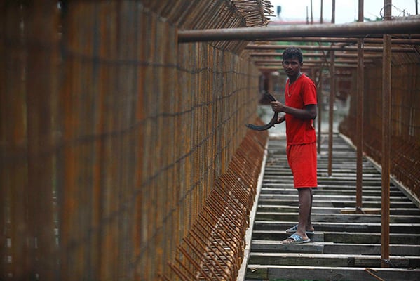 A worker stands on the Sundarighat Bridge over Bagmati river at Chobar on Friday.