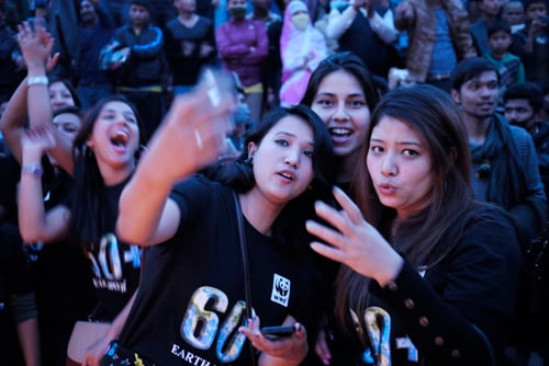 Girls take a selfie at an event held to mark Earth Hour at Hanumandhoka, Kathmandu on Saturday evening