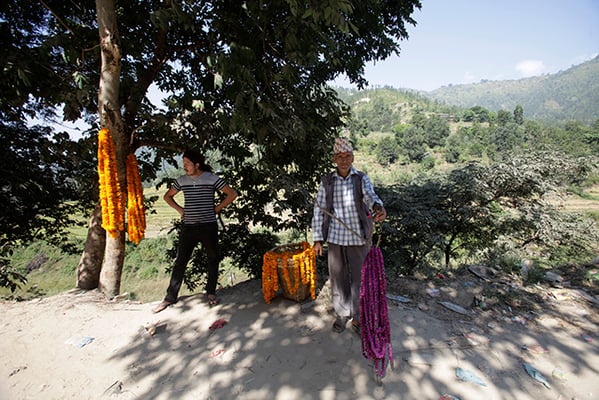 60-year-old Binod Paudel sells flower garlands in Khairghari, Dhading on Saturday.