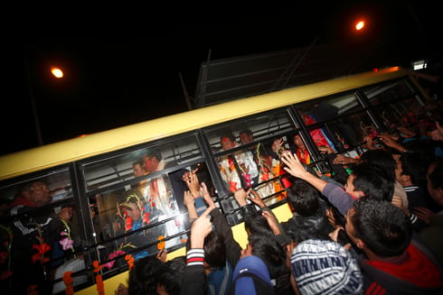 WELCOME HOME: Nepali cricket team surrounded by fans at the Tribhuwan International Airport on Sunday. The team returned from UAE after qualifying for the 2014 T20 World Cup .