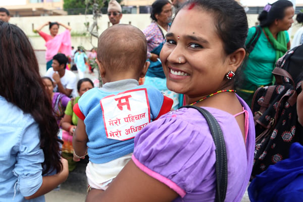 A woman carrying her baby participates in a rally held in Kathmandu on Wednesday demanding equal rights for women in the new constitution.