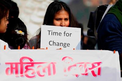 FLOWER-POWER: A woman takes part in the rally to celebrate International Women's Day at Shantibatika, Ratna Park on Friday.