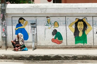 STREET LIFE: A man begs in front of Patan Mental Hospital in Lagankhel on Thursday.