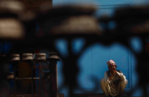81-year-old Asta Bahadur Prajapati rests near the Swayambhunath Stupa on Monday. He has been coming to the stupa to feed the monkeys for nearly 60 years.