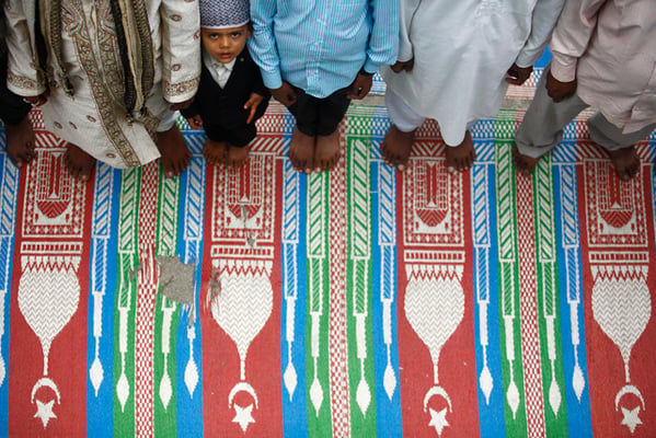 A little boy lines up to offer prayers during Eid at Kashmiri Mosque, Bagbazaar on Friday.
