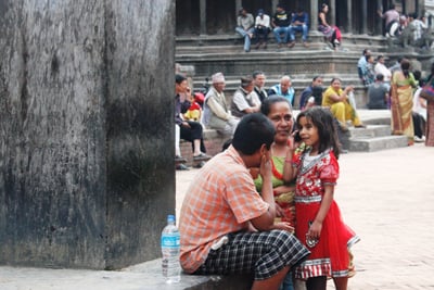 CALL ME BABY: A small girl talks to her father from her mum’s mobile phone at Mangal bazar on Tuesday.