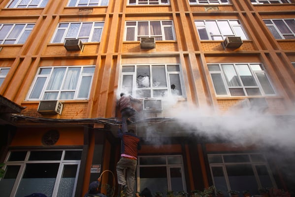 Locals try to douse a fire that broke out in a hotel building in Chhetrapati, Kathmandu on Thursday. The fire apparently caused by a short circuit was extinguished before a fire engine reached there.