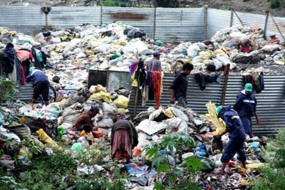 EARN A LIVING: A group of people separate rubbish for recycling at Balkumari bridge on Monday.
