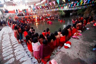 TOGETHER WE PRAY: Women pray before taking a bath together in the Salinadi River during the first day of Swasthani festival at Sankhu on Sunday.