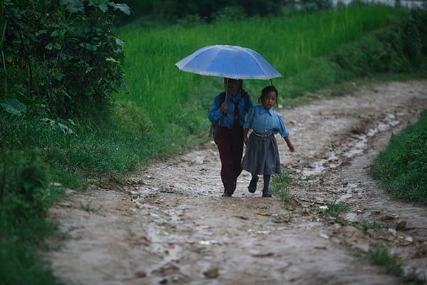 Two sisters return back from school at Gundu in Bhaktapur on Friday.