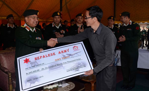 Nepal Army Chief Rajendra Chhetri hands over a cheque worth Rs 695,000 to Ganesh Bikram Singh at an event in Kathmandu on Tuesday. Singh's team has developed a Bomb Disposal Robot and handed it over to Nepal Army.